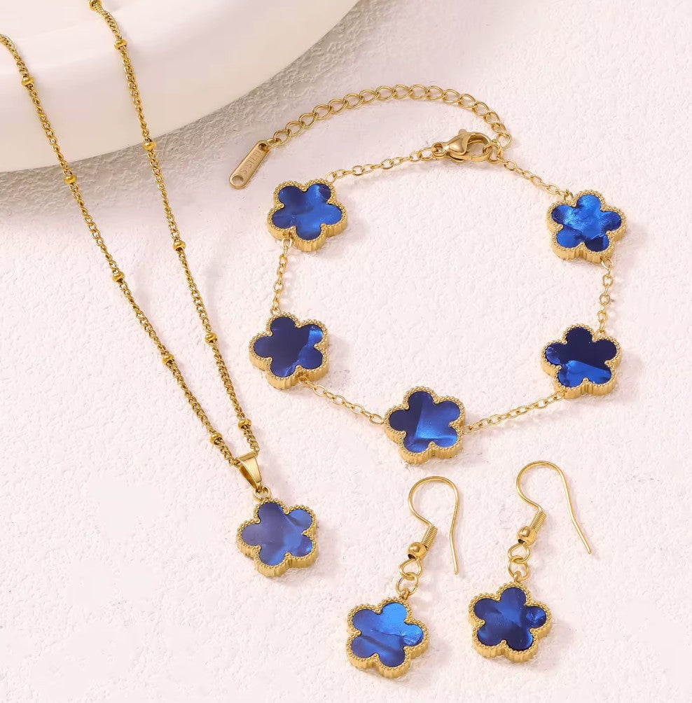 Aurelia Designs 3-piece jewellery set featuring blue shell clover charms on 18k gold-plated stainless steel chains.